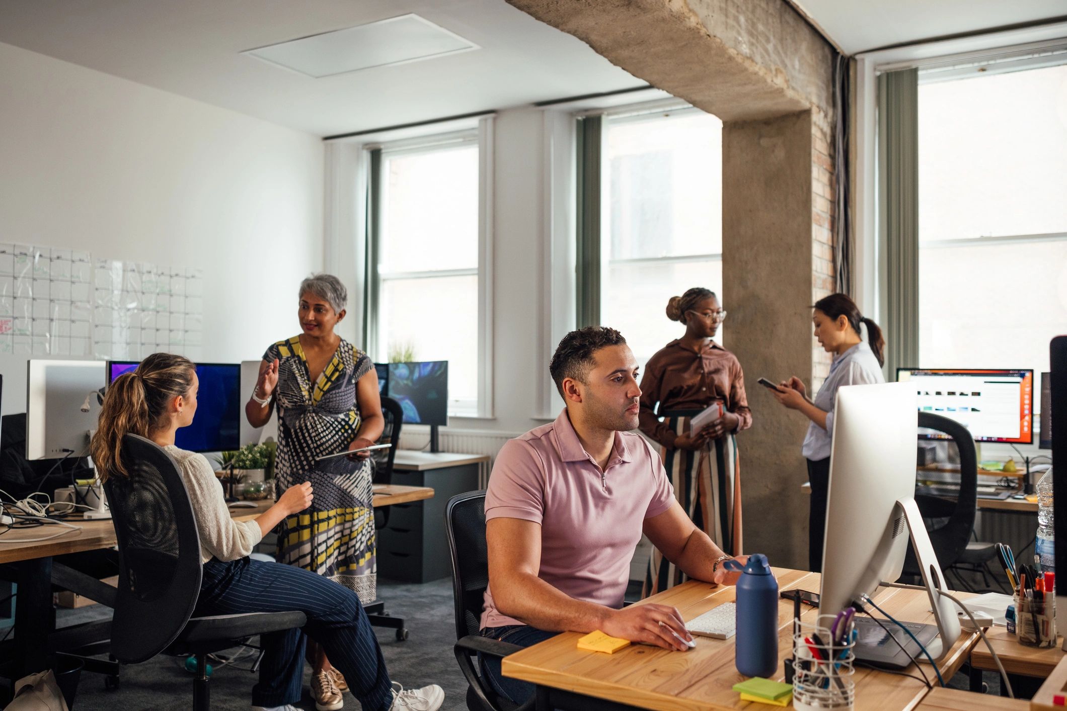 Atik Media team collaborating in a modern office